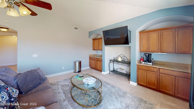 living room featuring vaulted ceiling and ceiling fan