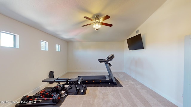 exercise area with light carpet and ceiling fan