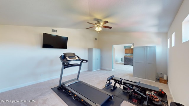 exercise area with vaulted ceiling, ceiling fan, and light colored carpet