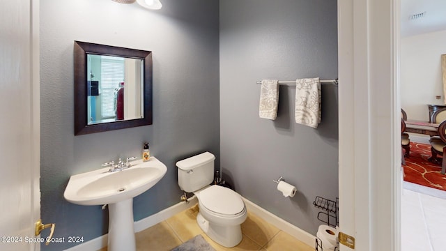 bathroom featuring tile patterned flooring and toilet