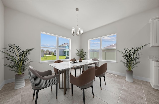 dining area featuring an inviting chandelier and light tile patterned floors