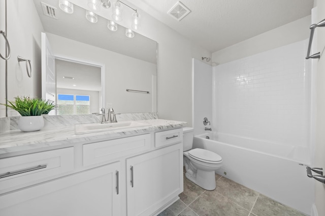 full bathroom with vanity, a textured ceiling, washtub / shower combination, tile patterned floors, and toilet