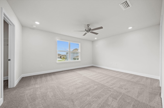 empty room featuring light carpet and ceiling fan