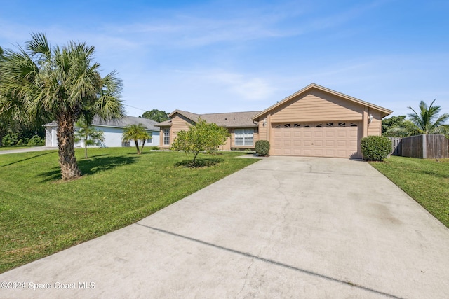 ranch-style house with a garage and a front lawn