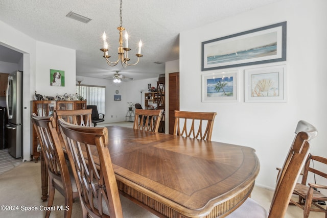 carpeted dining area featuring ceiling fan with notable chandelier and a textured ceiling