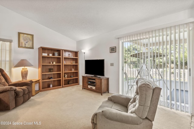 living room featuring carpet flooring, a textured ceiling, and vaulted ceiling