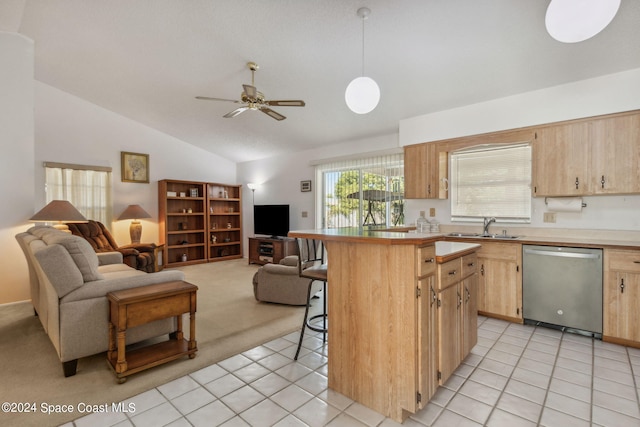 kitchen with lofted ceiling, stainless steel dishwasher, pendant lighting, a breakfast bar area, and light tile patterned floors