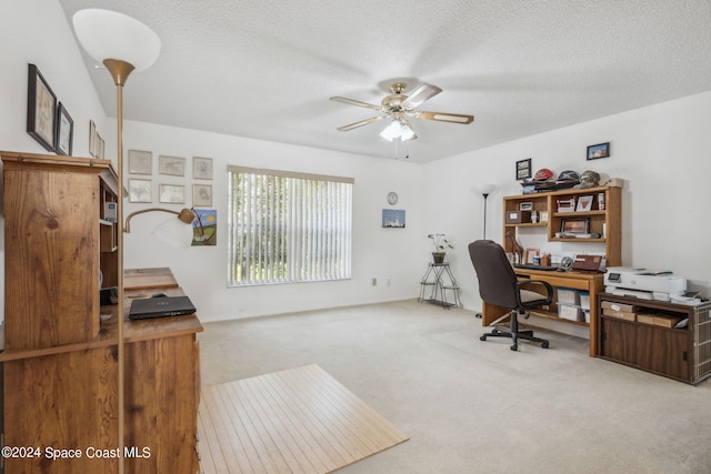 office area with a textured ceiling, ceiling fan, and carpet flooring