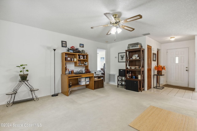 misc room featuring light carpet, a textured ceiling, and ceiling fan