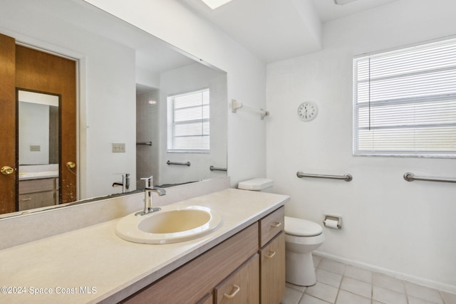 bathroom featuring tile patterned flooring, vanity, and toilet