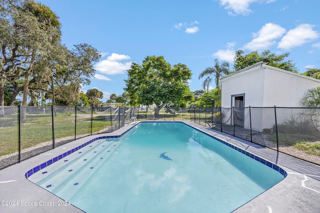 view of pool featuring a lawn