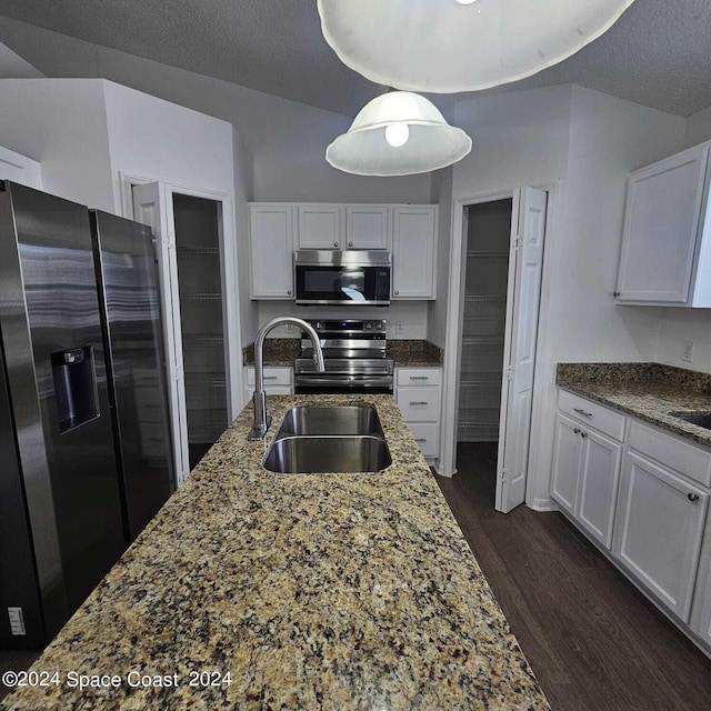 kitchen featuring appliances with stainless steel finishes, sink, dark hardwood / wood-style flooring, and white cabinetry