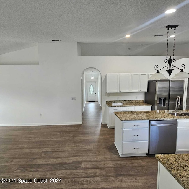 kitchen with white cabinets, hanging light fixtures, sink, appliances with stainless steel finishes, and dark hardwood / wood-style flooring