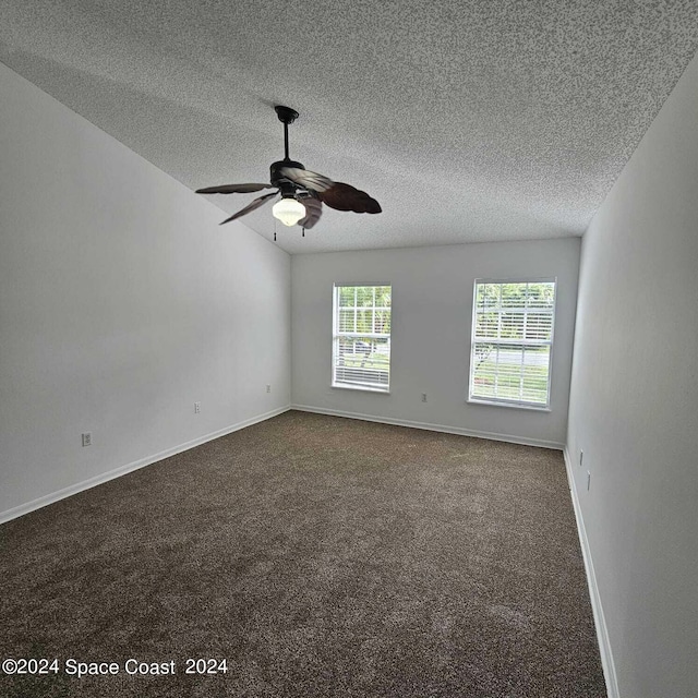 empty room featuring a textured ceiling, carpet flooring, and ceiling fan