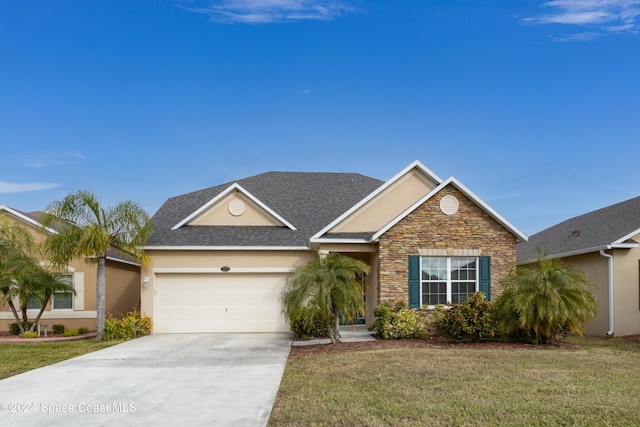 view of front of home with a front yard and a garage