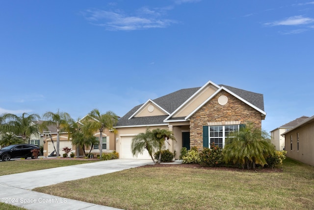 view of front of property with a front yard and a garage