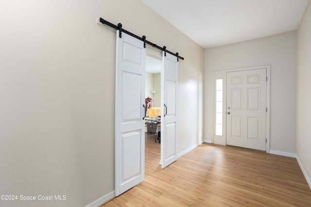 entryway featuring light wood-type flooring and a barn door