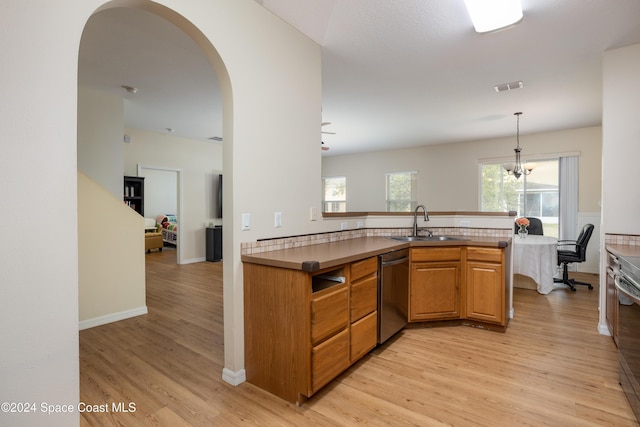 kitchen with dishwasher, sink, hanging light fixtures, light hardwood / wood-style floors, and kitchen peninsula