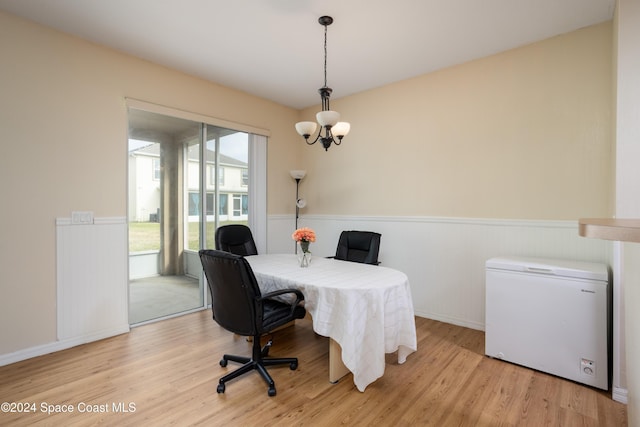 office area with a chandelier and light wood-type flooring