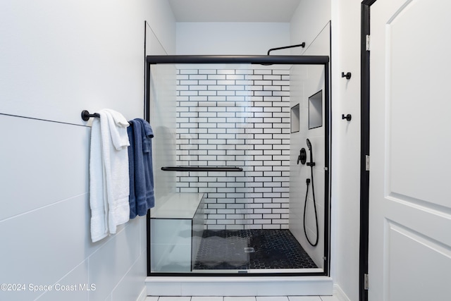 bathroom with a shower with shower door