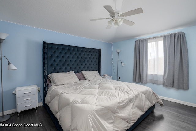 bedroom featuring dark hardwood / wood-style floors and ceiling fan