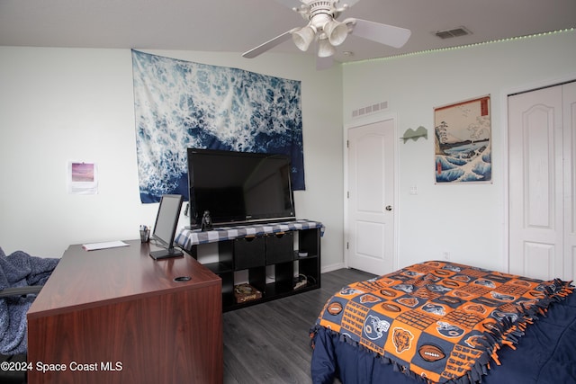 bedroom with a closet, vaulted ceiling, ceiling fan, and dark wood-type flooring