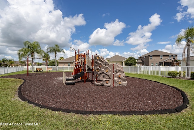 view of jungle gym with a lawn and a water view