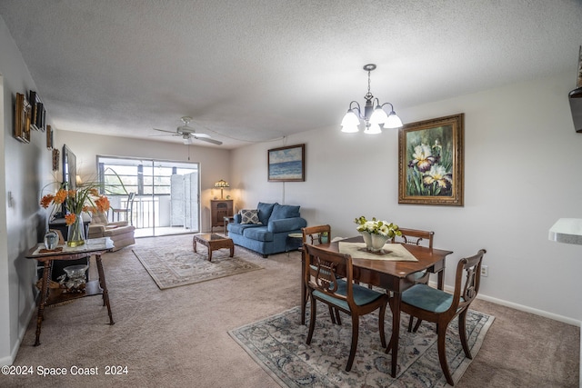 carpeted dining space with ceiling fan with notable chandelier and a textured ceiling