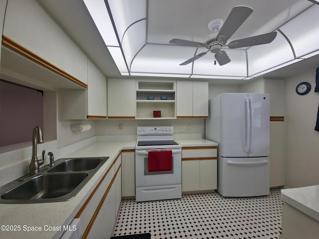 kitchen with white appliances, light countertops, a ceiling fan, light floors, and a sink