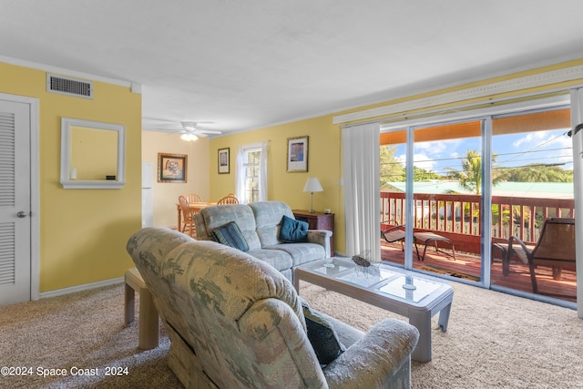 carpeted living room with ceiling fan