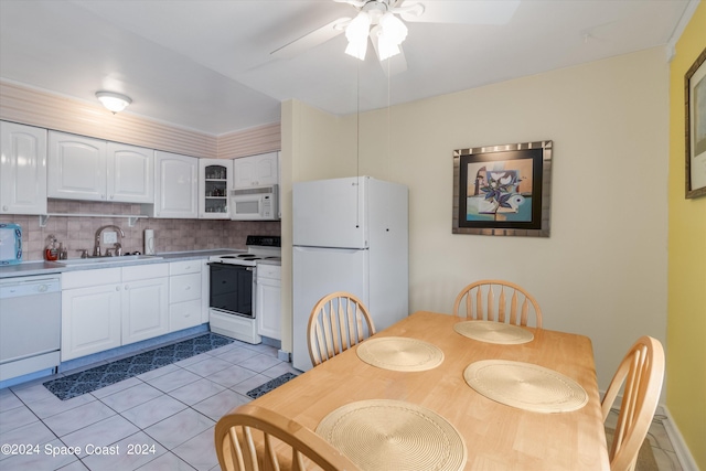 kitchen with ceiling fan, white cabinets, sink, tasteful backsplash, and white appliances