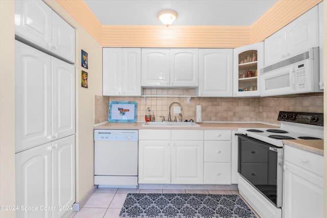 kitchen featuring white appliances, white cabinetry, sink, and light tile patterned floors