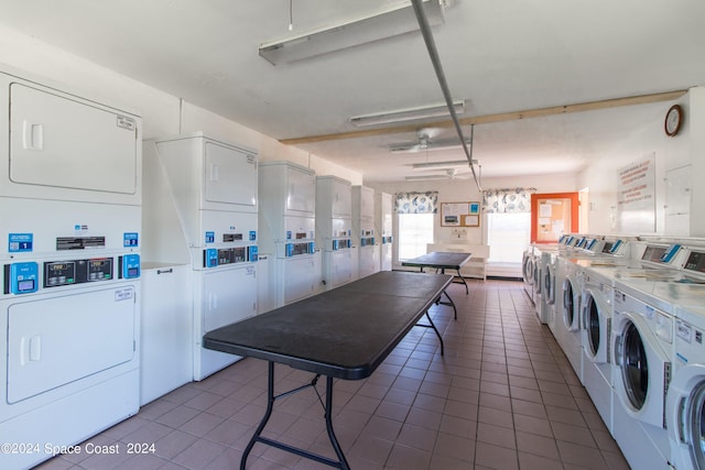 laundry room featuring dark tile patterned floors, stacked washer / dryer, and independent washer and dryer