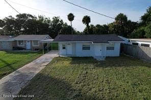 view of front facade featuring a carport and a front yard