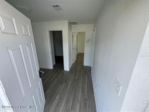 hall with dark wood-type flooring