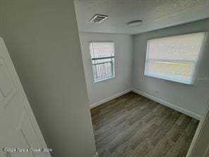 unfurnished room with hardwood / wood-style floors