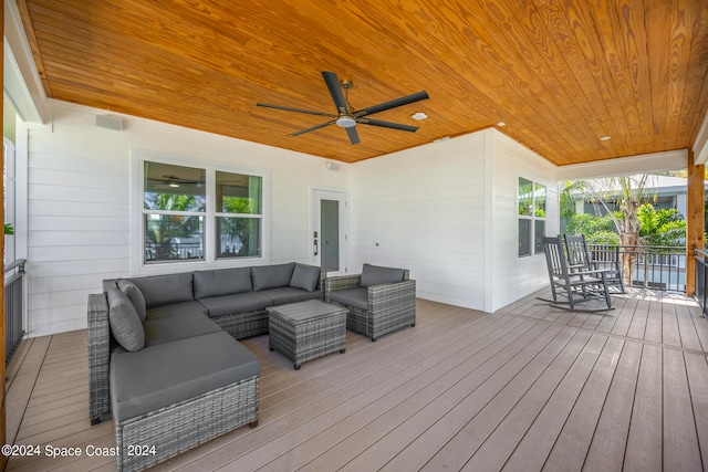 wooden terrace featuring ceiling fan and an outdoor living space