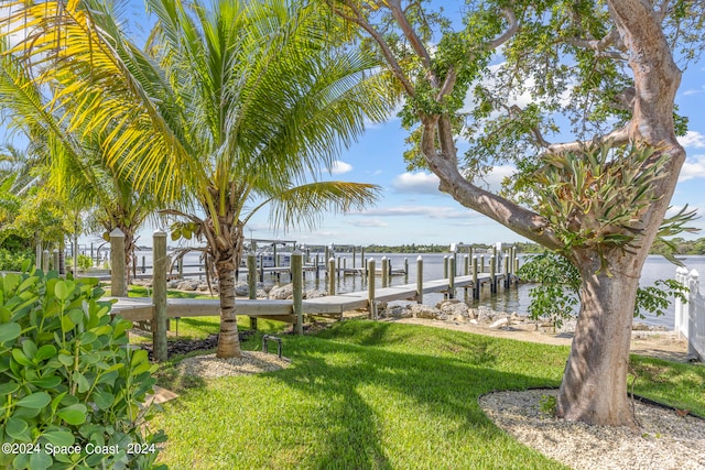 dock area featuring a water view and a yard