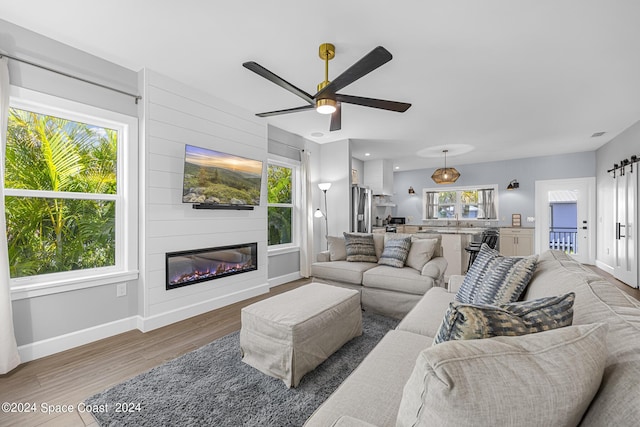 19 Vip Is Unit A, Grant, FL 32949 - living area featuring baseboards, wood finished floors, ceiling fan, and a large fireplace