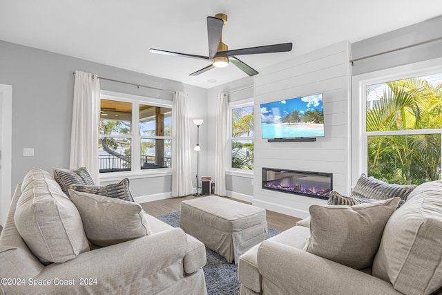 19 Vip Is Unit A, Grant, FL 32949 - living area featuring healthy amount of natural light, wood finished floors, a glass covered fireplace, and baseboards