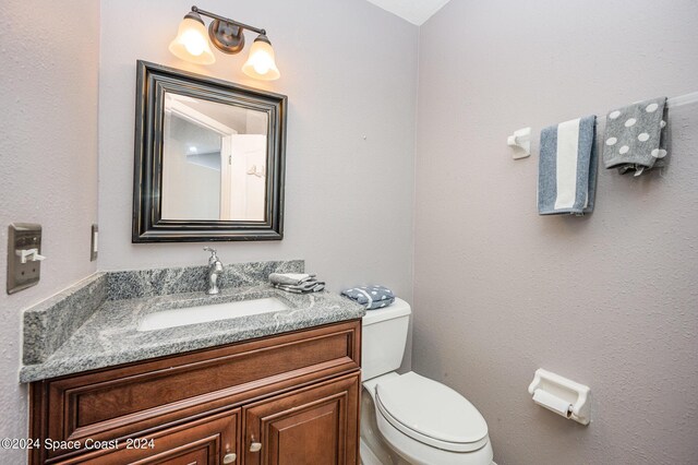 bathroom featuring vanity and toilet