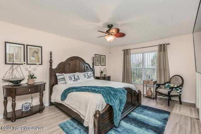 bedroom with ceiling fan and light hardwood / wood-style floors