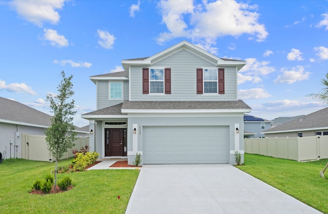 view of property featuring a front yard and a garage