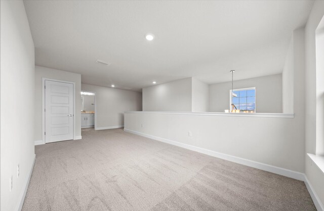 unfurnished room with recessed lighting, baseboards, and carpet floors