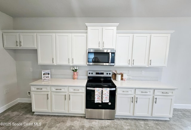 kitchen with white cabinets, stainless steel appliances, and light countertops