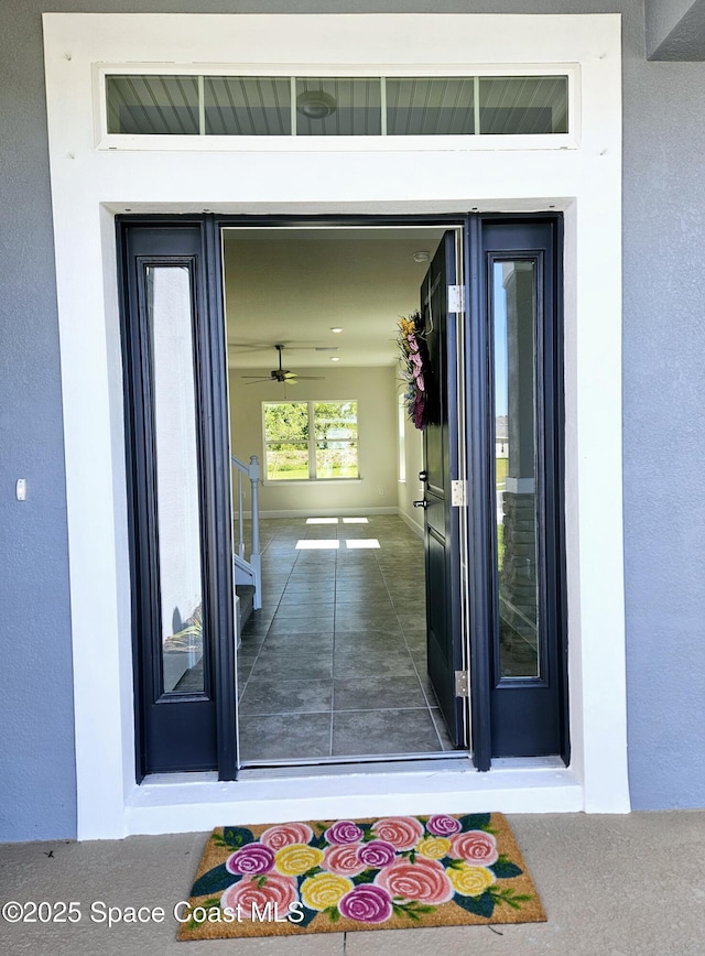 view of exterior entry featuring stucco siding