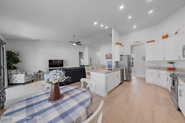 kitchen featuring stainless steel appliances, white cabinetry, ceiling fan, and sink