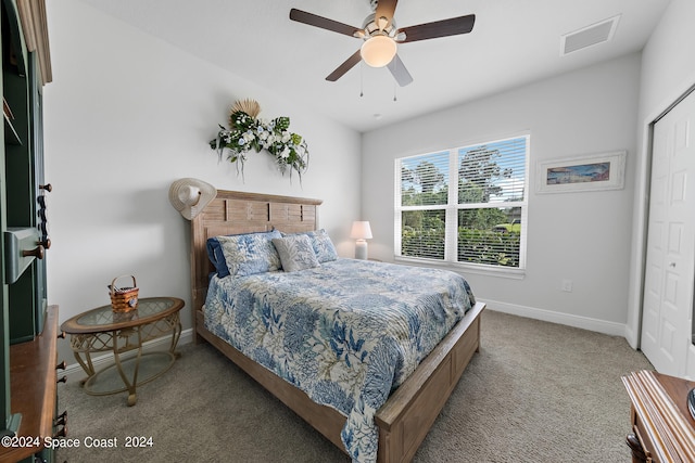 carpeted bedroom featuring ceiling fan and a closet