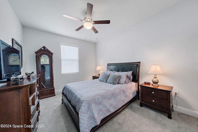 bedroom with ceiling fan and light colored carpet