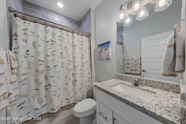 full bathroom with shower / bath combo, vanity, and toilet